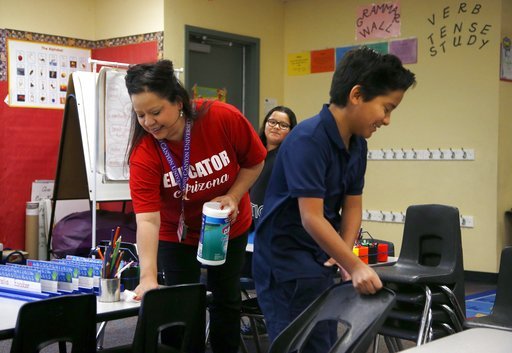 凤凰城一位小学教师与学生正在清理教室（照片：美联社）
